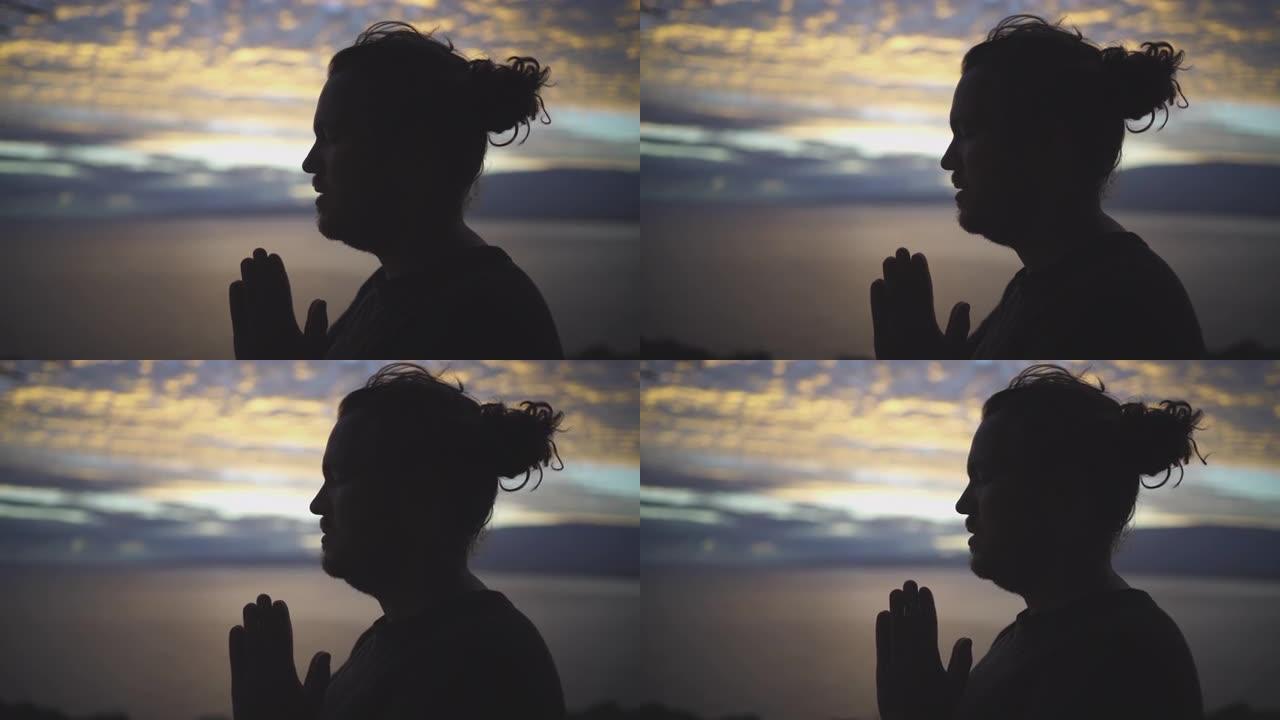 一个年轻人做瑜伽的剪影，背后是海洋日落