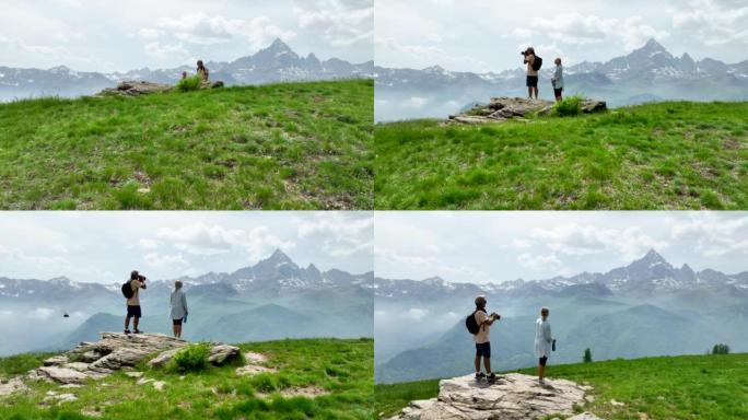 徒步旅行夫妇到达山顶并欣赏山景的鸟瞰图