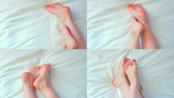 白色孩子的赤脚。特写。爪子左右移动。懒惰的早晨，觉醒