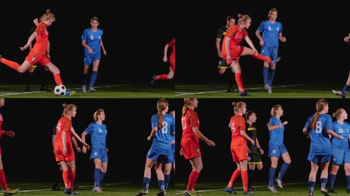 穿着红色服装的SLO MO LD女足球运动员在晚上的比赛中踢球
