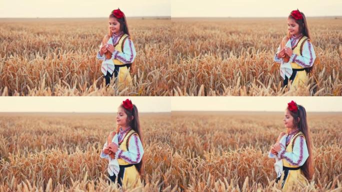 美丽的女孩女人穿着传统的保加利亚民俗服装，在麦田，农业和本土食品概念中拿着自制面包