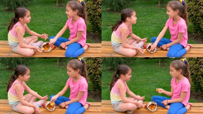 这个孩子在公园里吃薯条。选择性聚焦。孩子。