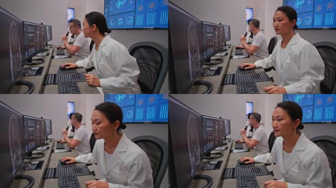 LD放射学女医生在计算机上分析MRI扫描