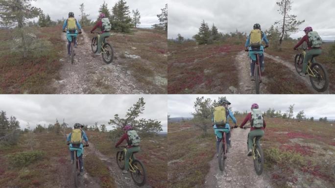在一片空地上，一男一女骑着山地自行车在小径上拍摄