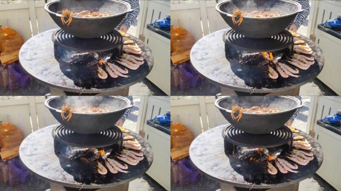 虾和螃蟹在圆形铸铁户外烤架上煮熟，中间有火。海鲜烧烤。野餐是用明火煮的。莫斯科的鱼周