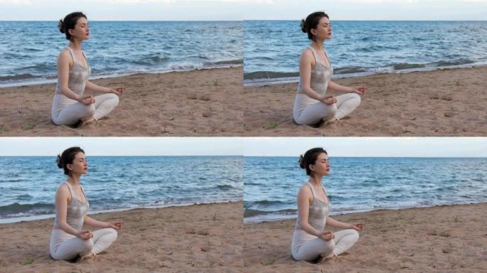 女人在海滩上的莲花姿势在外面练习瑜伽