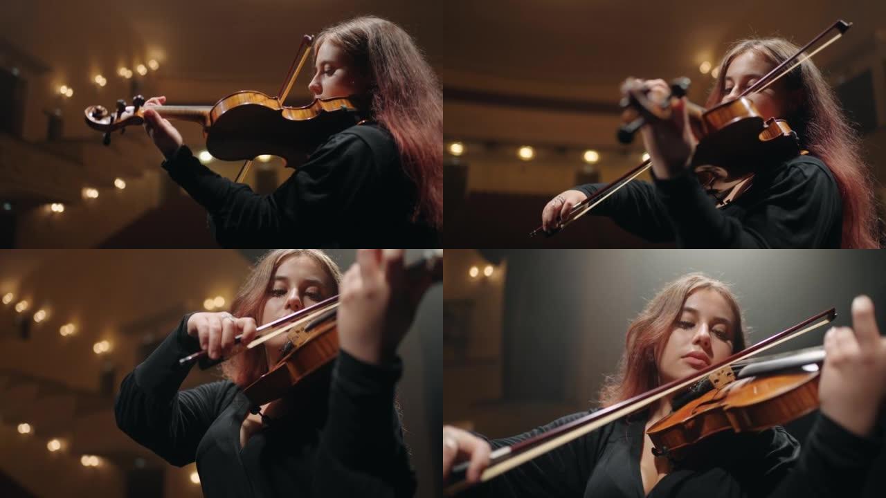 交响乐团音乐会，女小提琴演奏者在现场表演音乐