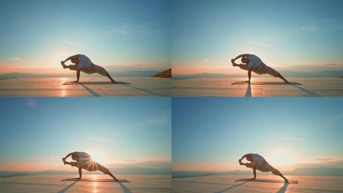 CS男子在日落时在山顶上做瑜伽姿势