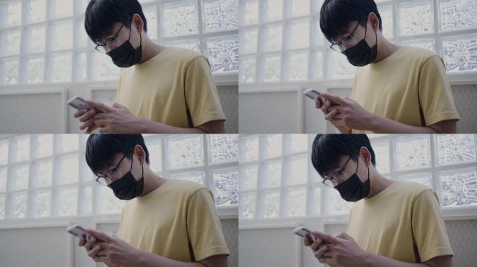 穿着黑色面具的男人使用手机