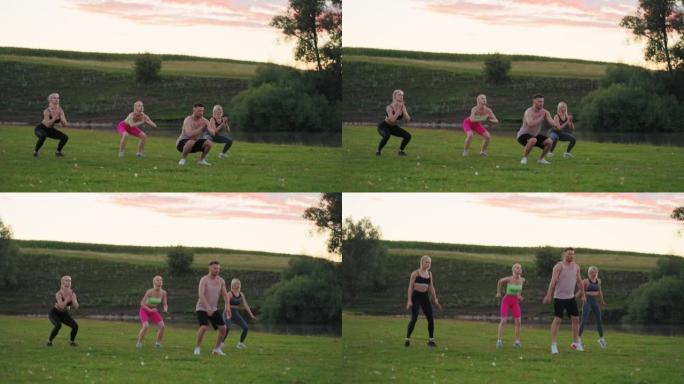 集体健身锻炼在大自然中，三名女运动员和英俊的健身教练在跳跃和蹲着