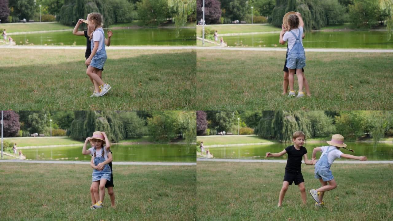 有趣的孩子在草地上摔倒在一起在公园跳舞跳跃玩得开心