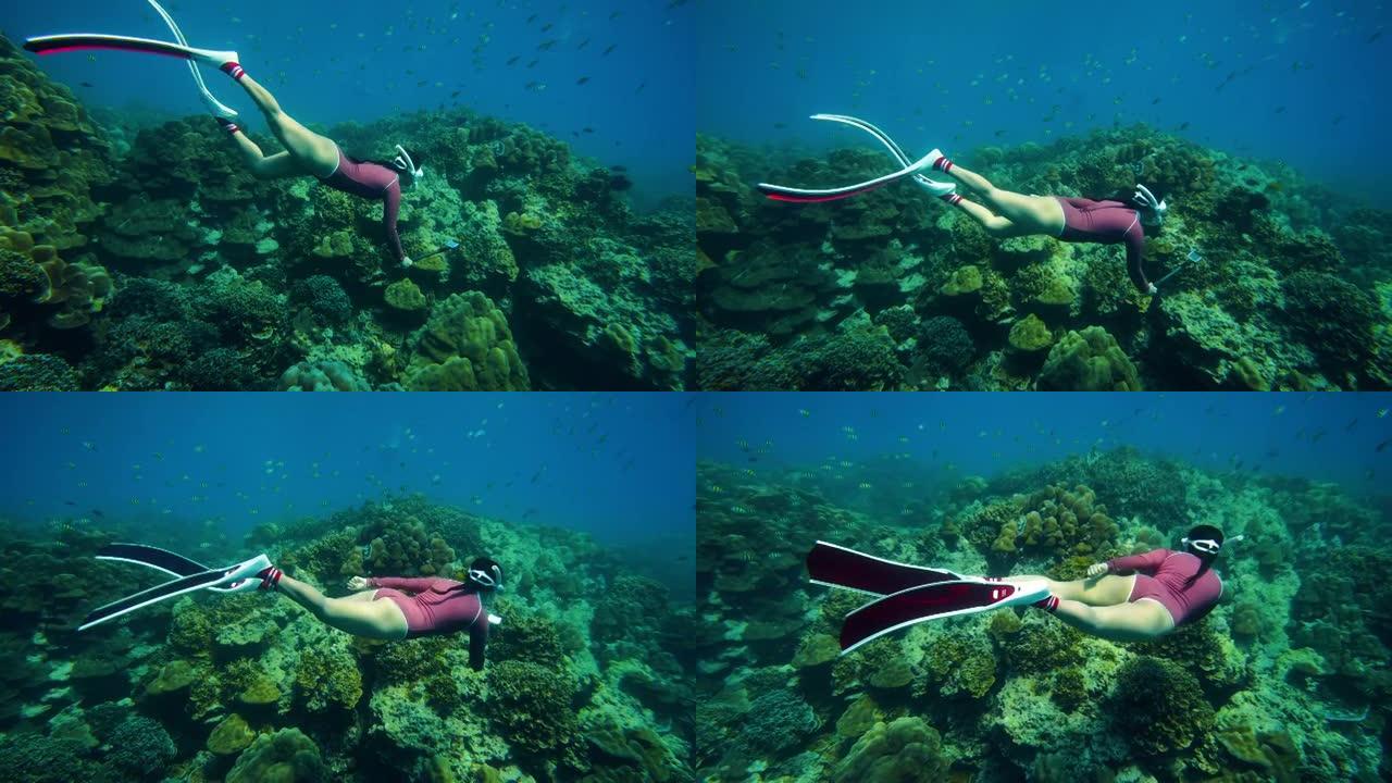 女潜水员在水下拍摄美丽风景