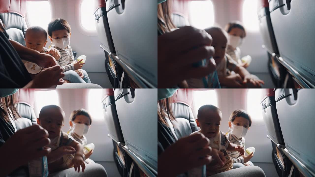 亚洲父母有两个儿子乘商用飞机旅行
