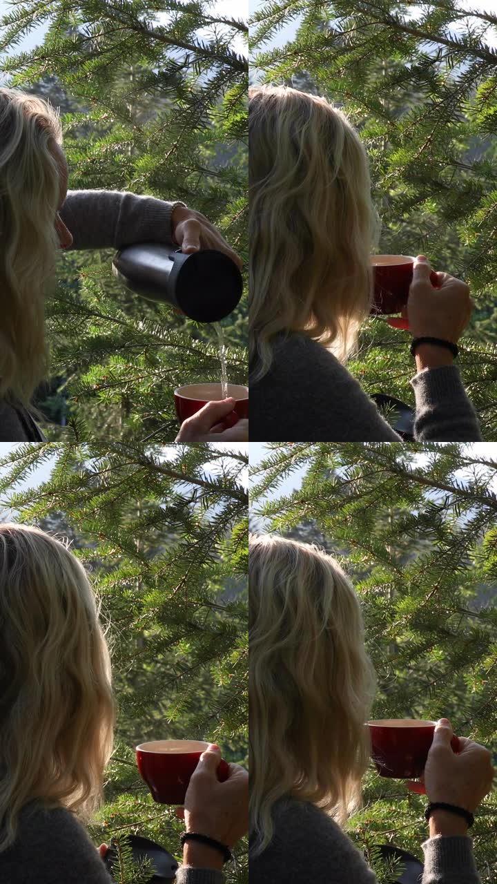 女性徒步旅行者在森林中享受清凉饮料