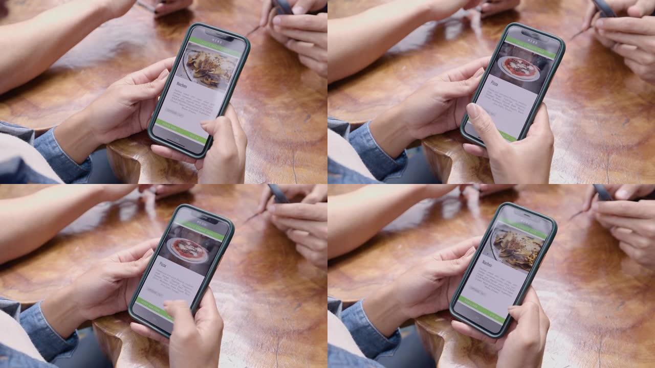 一群无法识别的顾客在智能手机上查看餐厅的菜单