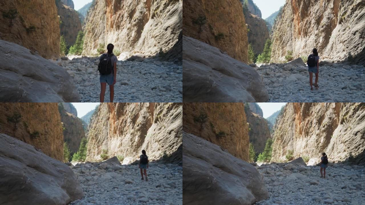 女人散步和欣赏岩石悬崖