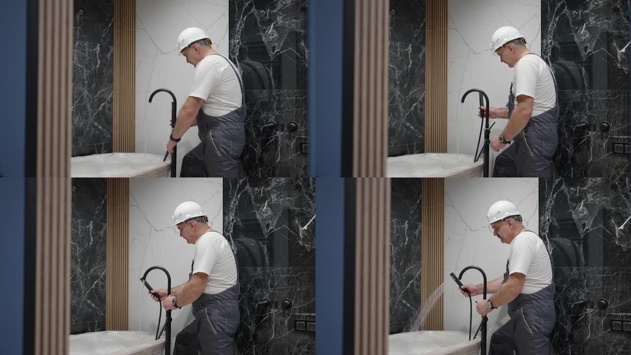 水管工检查浴缸中水龙头和淋浴喷头的操作