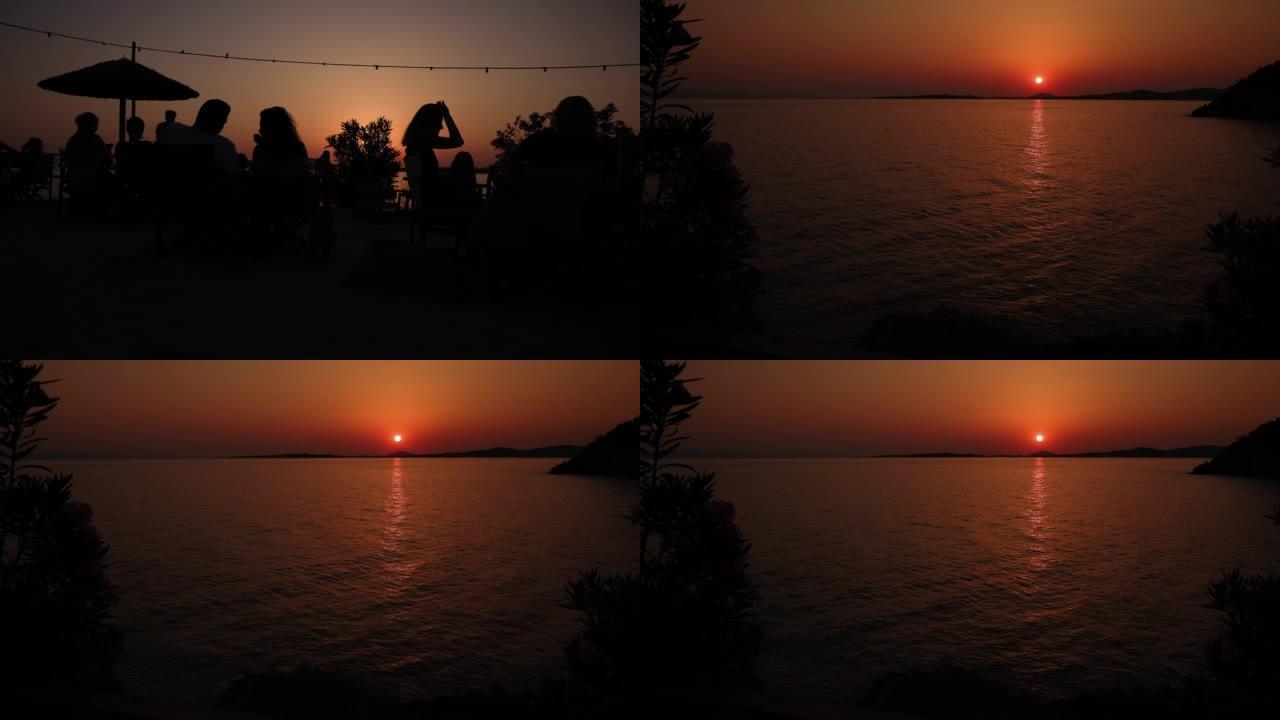 视频蒙太奇的人坐在沙滩上，一边欣赏海上的日落