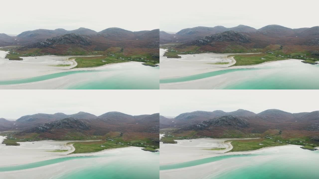 空中无人机在阴天拍摄了一条小直道，靠近绿水青山的沙滩