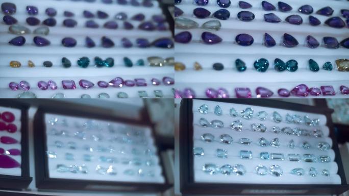 珠宝店陈列柜玻璃后面一排排美丽的昂贵宝石