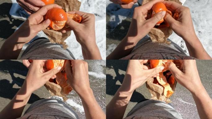 刚刚从袋子里取出的去皮橙子的手的细节
