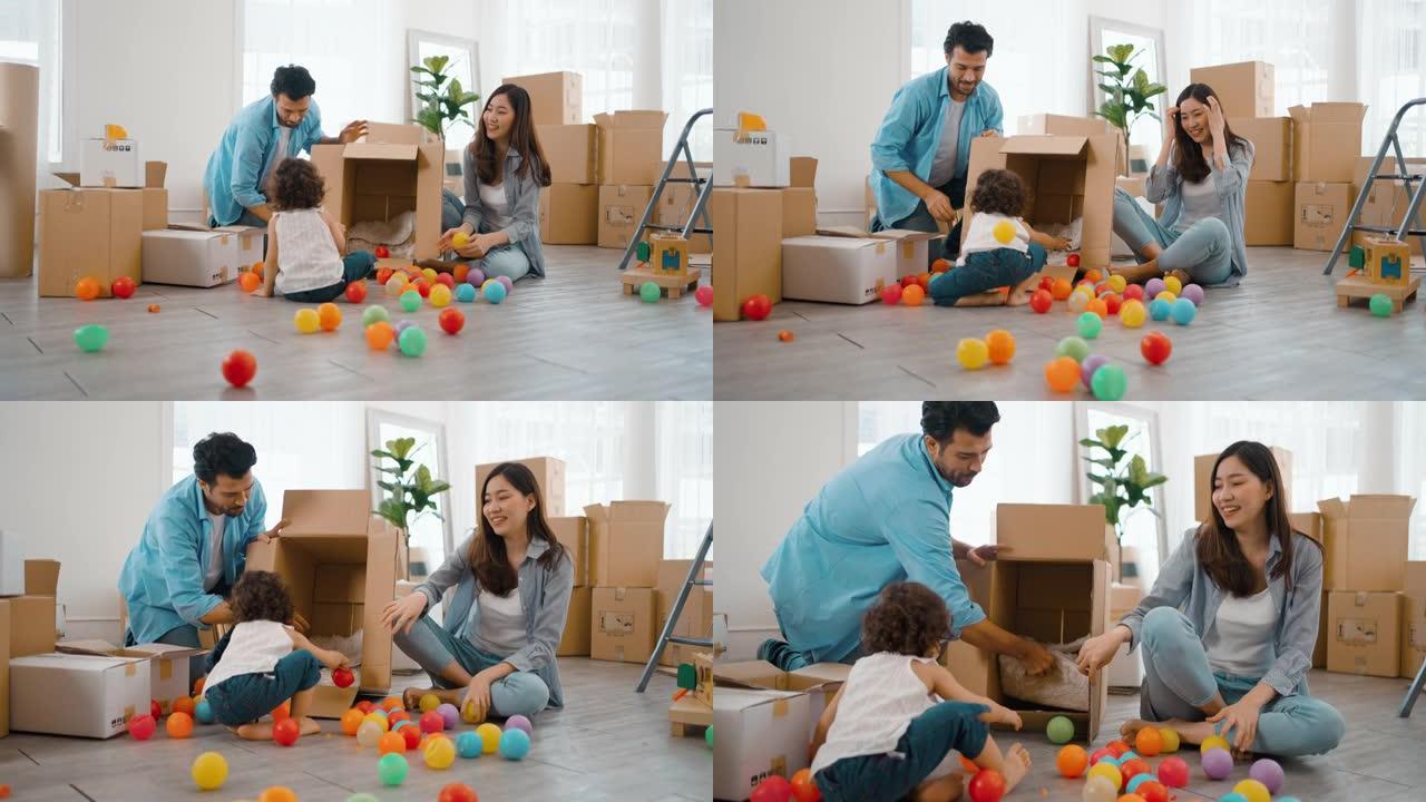 幸福的家庭和他的女儿一起玩耍，同时打包纸箱存放