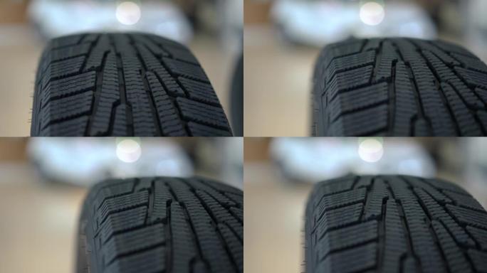 高品质黑色橡胶汽车轮胎特写。汽车经销商的室内车轮零件待售。汽车工业和商业概念。