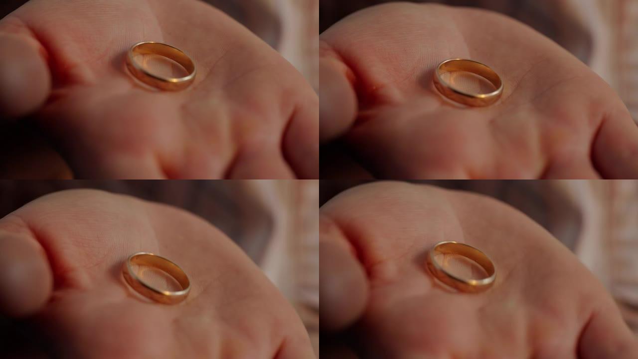 手掌上的金色结婚戒指，关于婚姻的想法，珠宝的选择