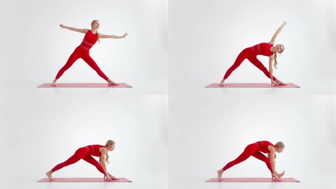 千禧一代女性在瑜伽中伸展姿势冥想，在红色运动服的白色背景下孤立。年轻的女瑜伽练习者为复制空间摆姿势的