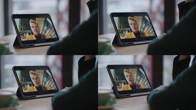 快乐的男人通过视频打电话给他的朋友或同事女人，平板电脑屏幕上的男性面孔