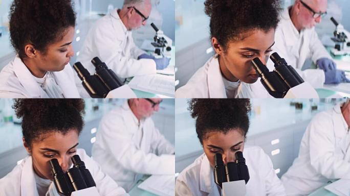 非洲，有显微镜的女科学家。戴着防护手套。背景中的成熟医生