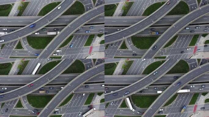 城市交通过度流失。汽车在高速公路上四处行驶。高架大交叉路口的鸟瞰图