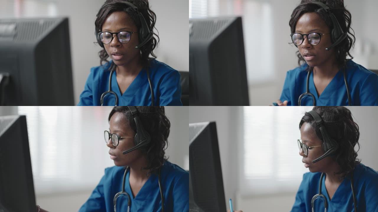 黑人女医生穿着白大褂，戴着眼镜和耳机与客户交谈，使用可视电话。冠状病毒大流行爆发治疗师远程工作通过视