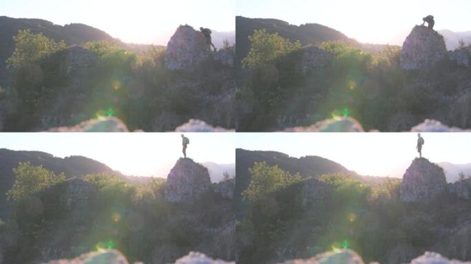 男性徒步旅行者登上岩石顶峰，俯瞰整个场景