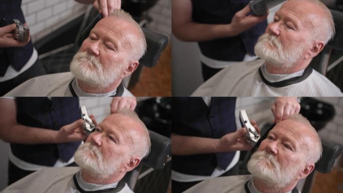 现代白发老人在理发店做头发和胡子的剪发和造型，特写