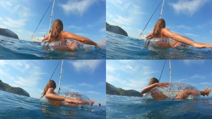 SLO MO女人在海里的大漂浮物上享受