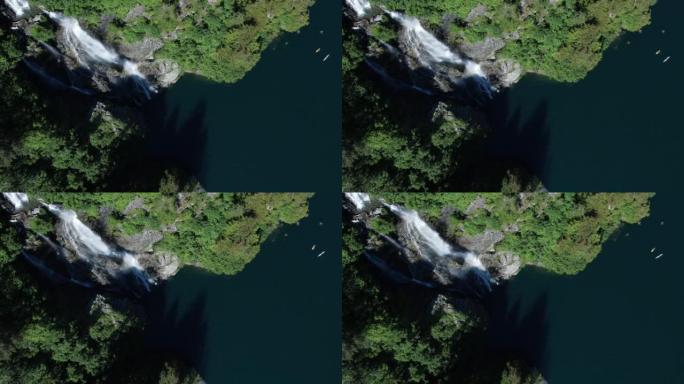空中无人机拍摄了两名皮划艇运动员在瀑布附近的湖上划桨