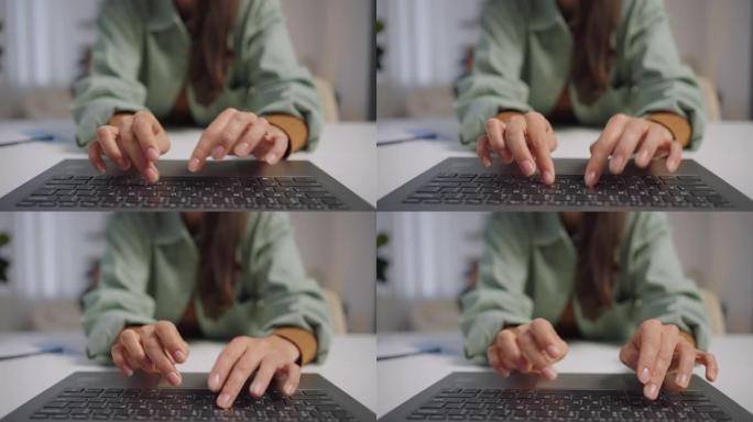 在笔记本电脑键盘上打字的手指特写。一个女作家，写评论，回复邮件。