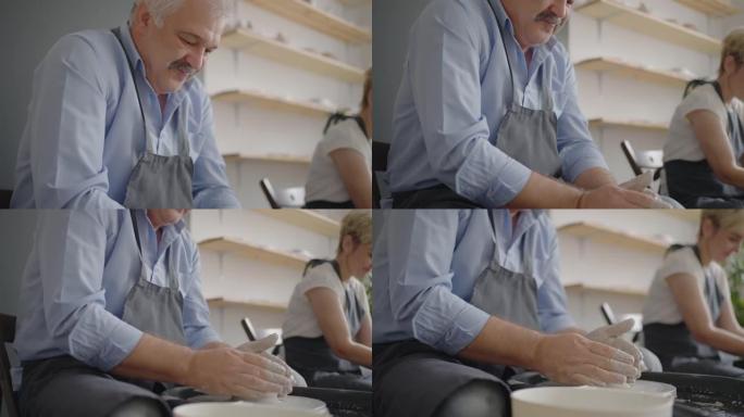 一位男性陶工在慢动作中制作陶瓷板的肖像