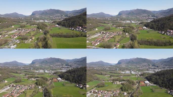 空中无人机拍摄了山区小镇附近的绿色牧场