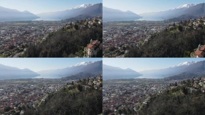 空中无人机拍摄了湖边城市和山脉上方人口稠密的山坡