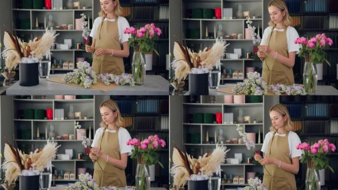 职业女性花店在花店工作时切一朵花创造美丽的花束。在花店工作室工作的花卉艺术家。手工花艺