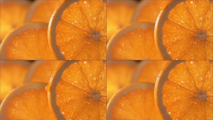一滴橙汁从成熟多汁的橙片表面流下。慢动作4K