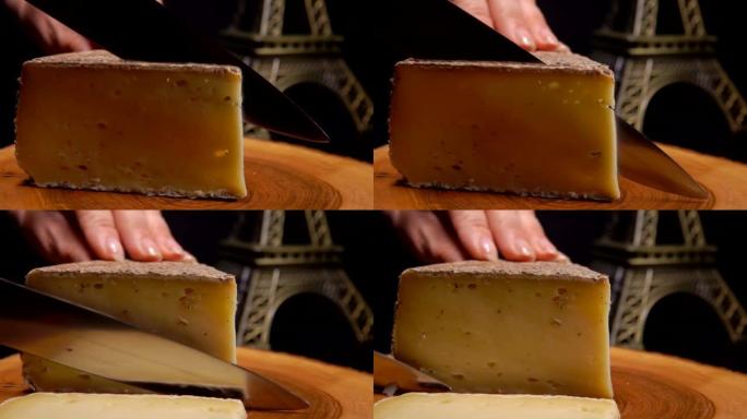 小刀在木板上慢慢切割坚硬的法国奶酪的特写