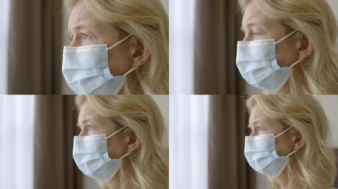 戴着医用面具的悲伤金发女子看着医院窗外，检疫
