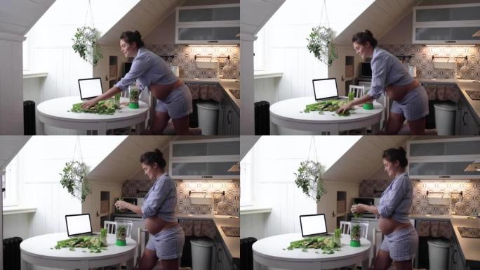Happy pregnant woman doing healthy green smoothie