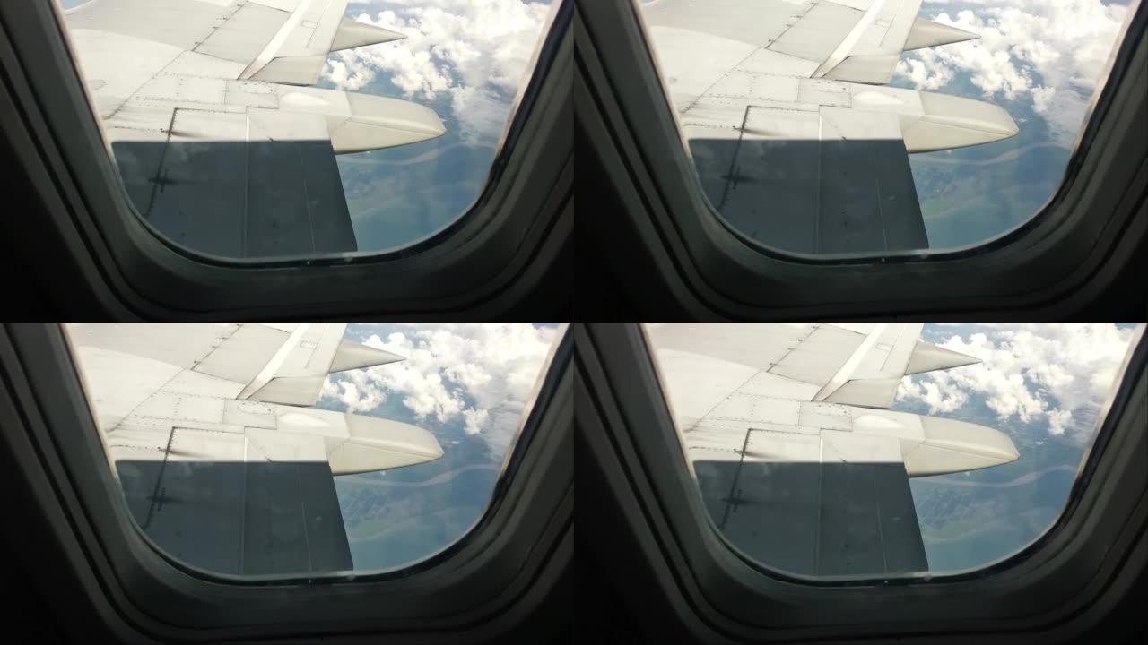 从飞机窗口蜿蜒河的空中无人机视图。陆地上茂密的植被。高清视频