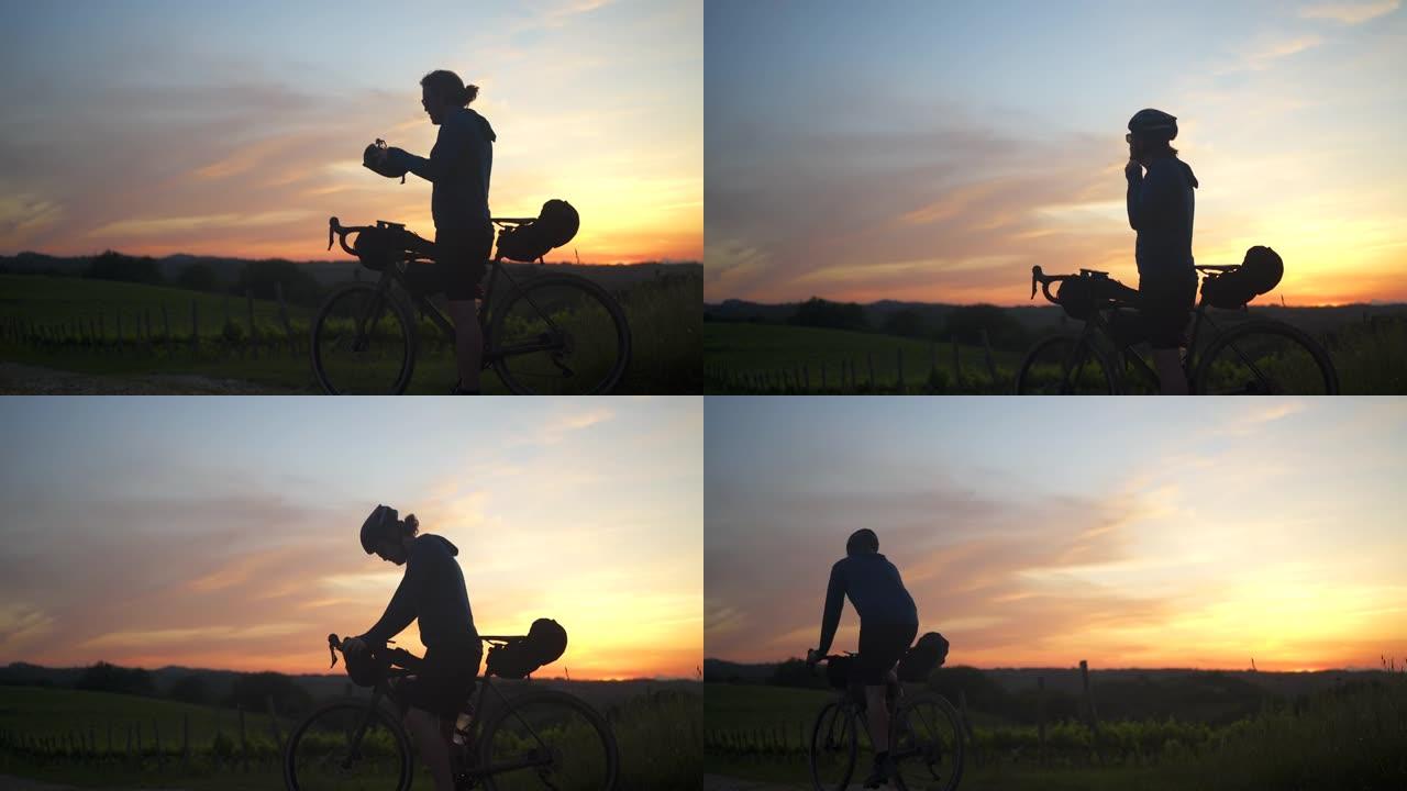 托斯卡纳日落时骑自行车探索碎石路和葡萄园的人