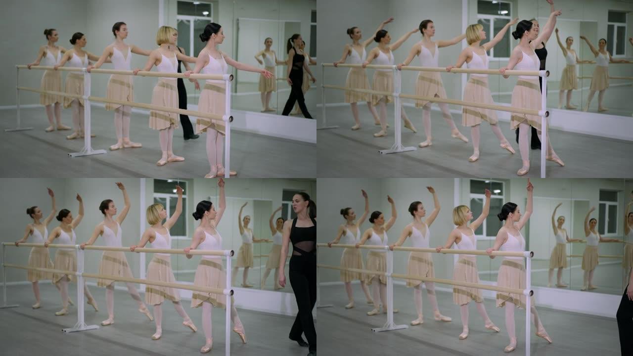 宽镜头聚焦的年轻高加索芭蕾舞演员在舞蹈工作室里散步时排练tendu。苗条华丽的才华横溢的女性在室内跳