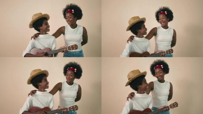 非洲兄弟姐妹男孩和女孩一起弹吉他